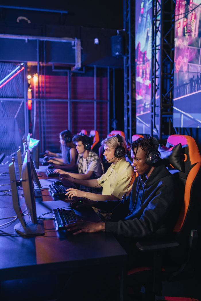 Crafting Captivating Headlines: Your awesome post title goes here Group of focused gamers playing during a professional esports event.