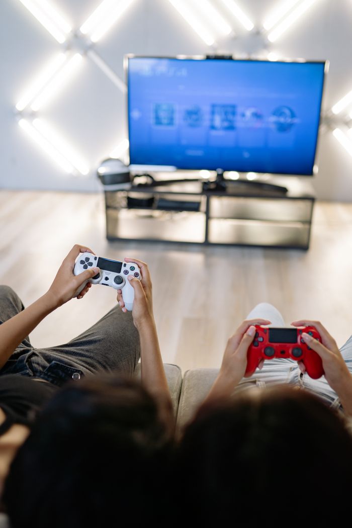 Mastering the First Impression: Your intriguing post title goes here Two people enjoying video games at home with wireless controllers.